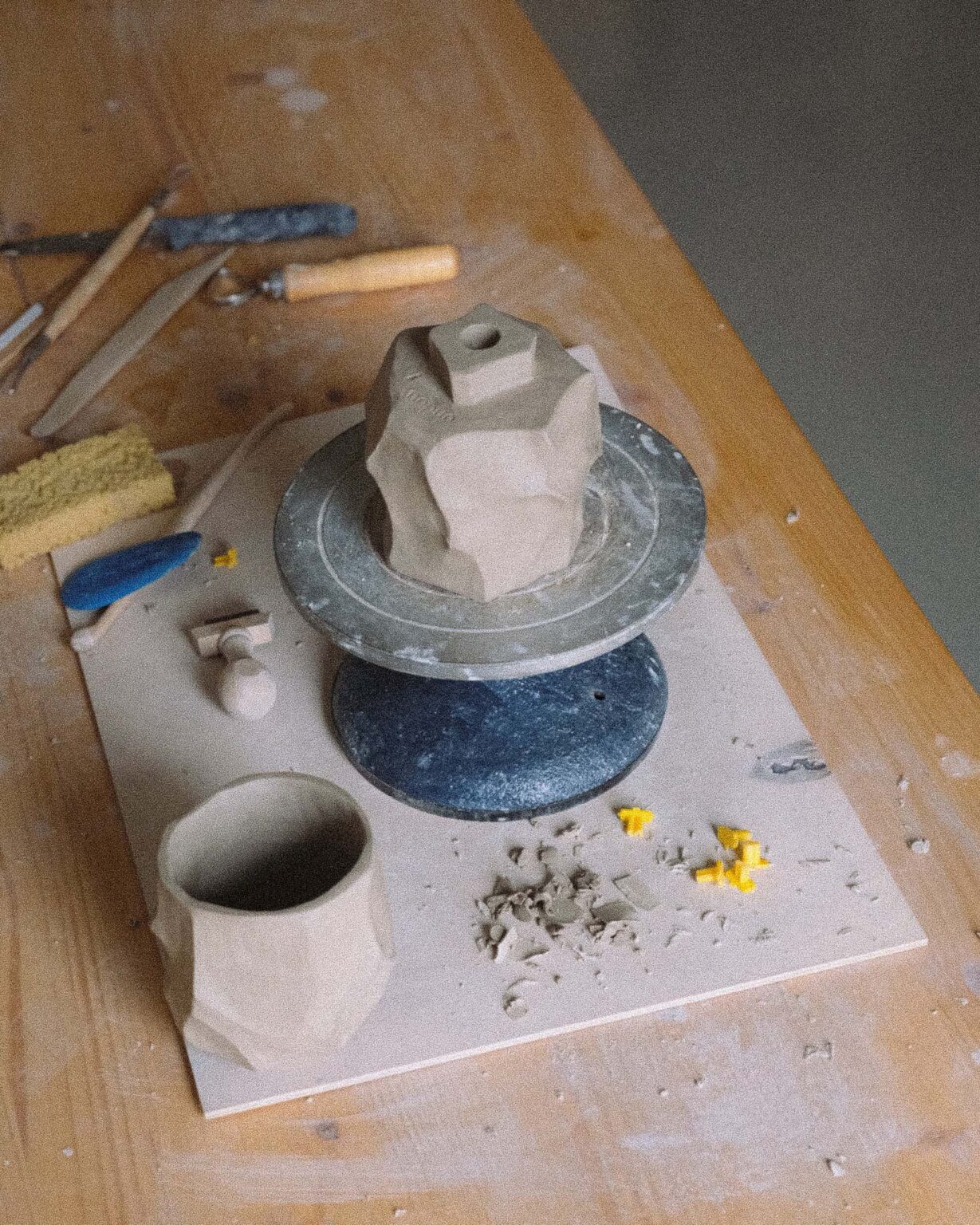 Behind-the-scenes shots of kurinuki cup creation in a tranquil, artistic ceramic studio, showcasing the detailed hand-carving process by the artist.