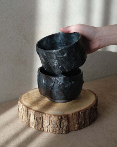 Hand-crafted Ondou Matcha Bowl Nº3 made from black stoneware, designed for mixing and sipping matcha. Features a unique, weighty design with hints of blue and deep brown.