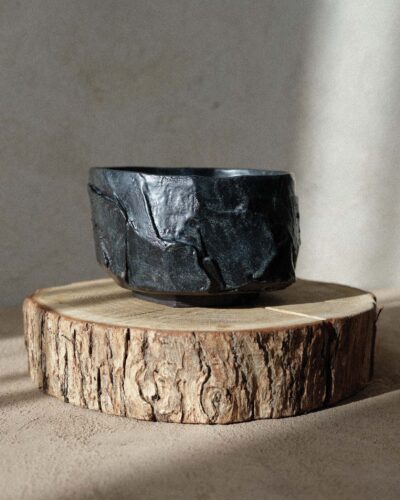 Hand-crafted Ondou Matcha Bowl Nº3 made from black stoneware, designed for mixing and sipping matcha. Features a unique, weighty design with hints of blue and deep brown.