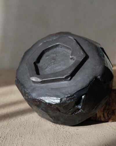 Hand-crafted Ondou Matcha Bowl Nº3 made from black stoneware, designed for mixing and sipping matcha. Features a unique, weighty design with hints of blue and deep brown.