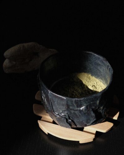 Hand-crafted Ondou Matcha Bowl Nº3 made from black stoneware, designed for mixing and sipping matcha. Features a unique, weighty design with hints of blue and deep brown.