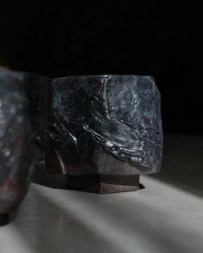 Hand-crafted Ondou Kurinuki Cup Nº1 made from black stoneware in a dramatic contrasted light.