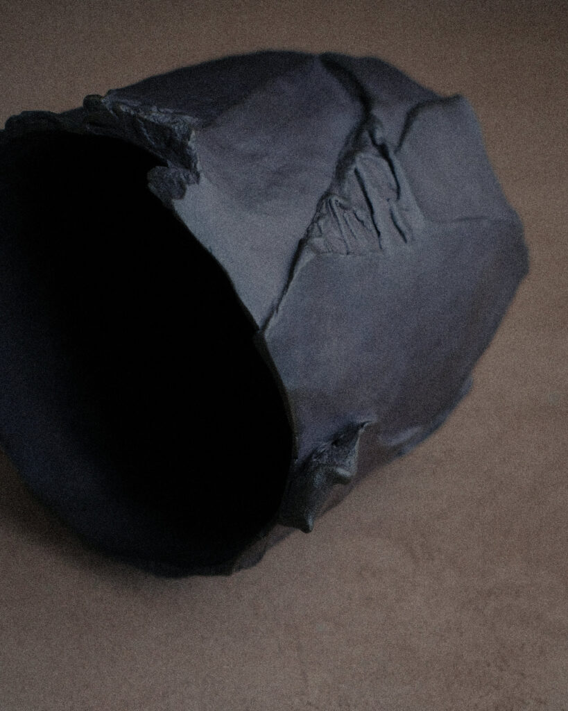 Large open kurinuki stoneware vessel viewed from above — hand-carved unglazed clay, wide sculptural opening